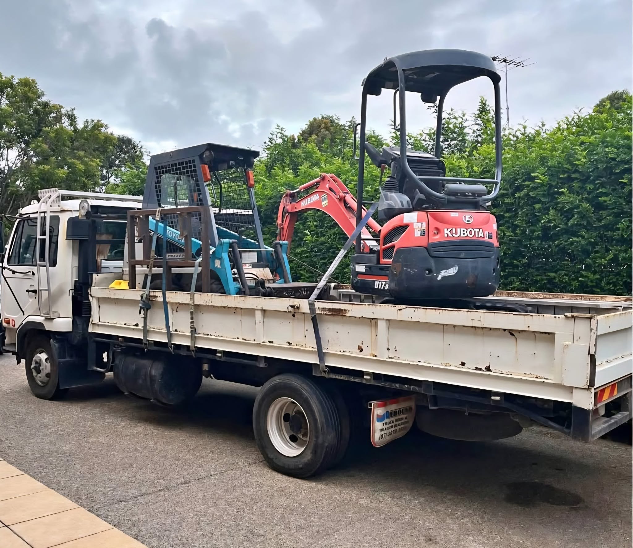 Mini excavator and loader on the truck, ready for a job